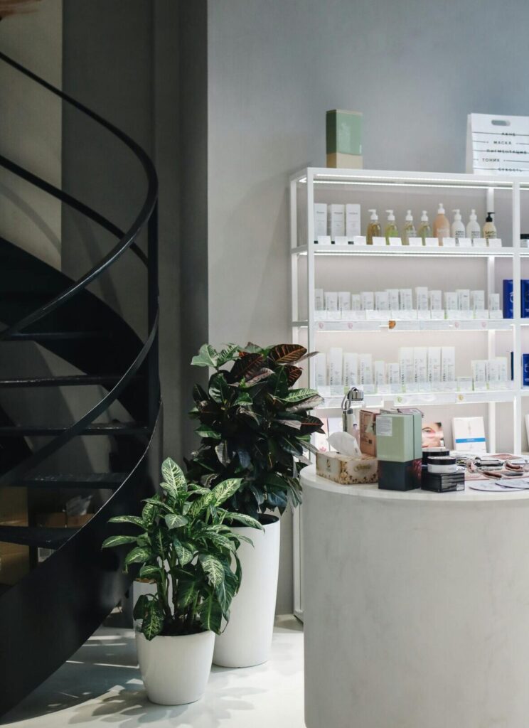 Contemporary beauty store interior showcasing various cosmetics on elegant shelves.